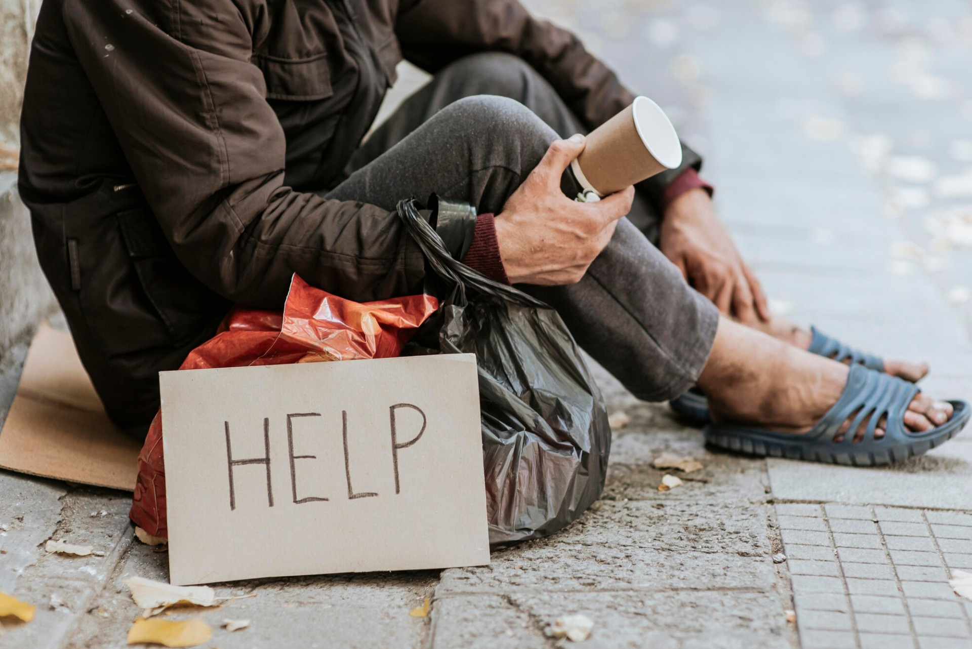 side-view-homeless-man-holding-cup-help-sign_23-2148760789.jpg