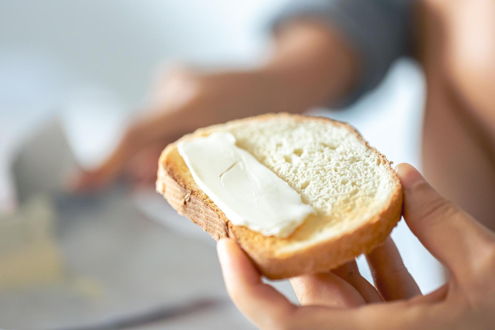 piece-bread-with-butter-womans-hand_169016-48422.jpg