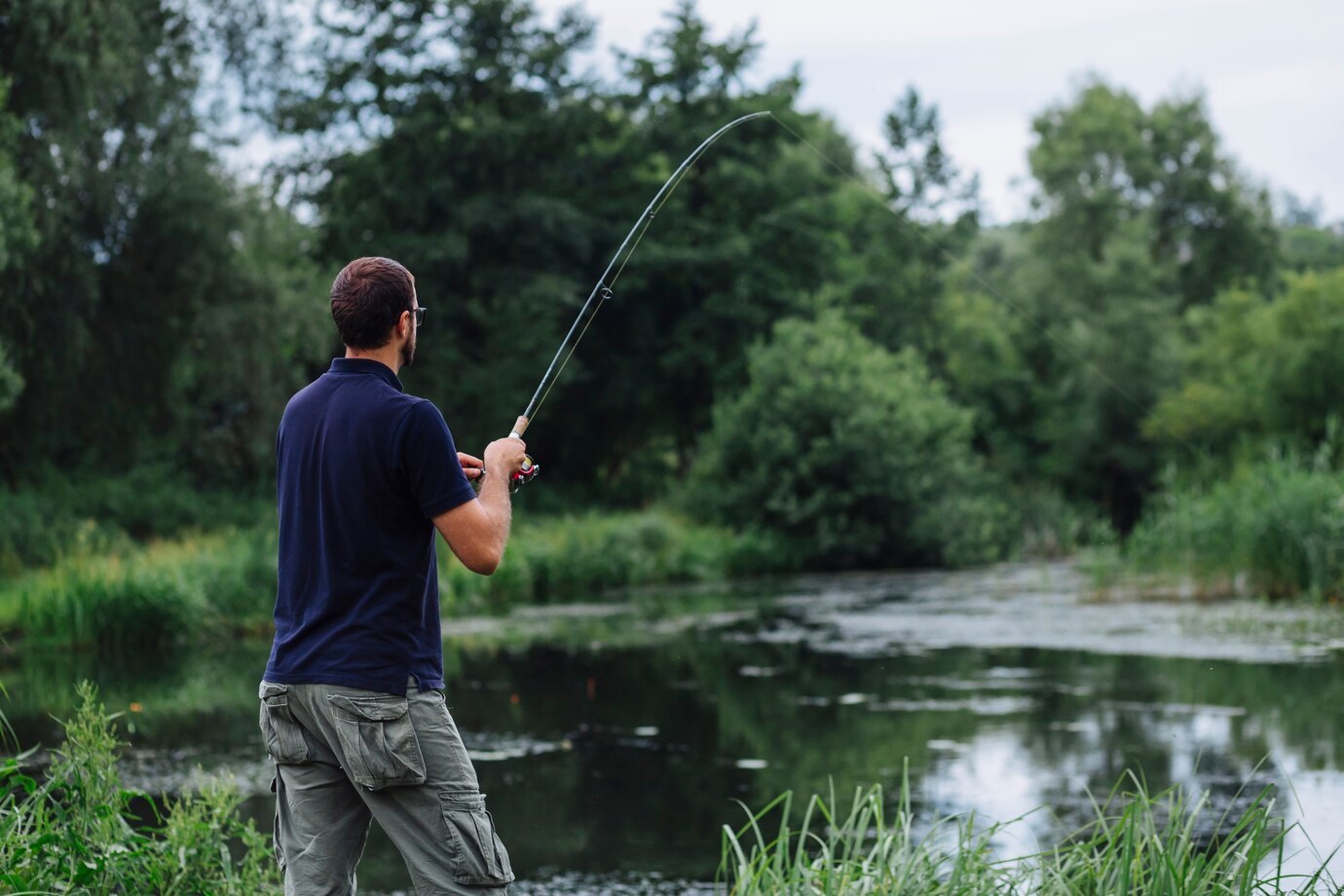 close-up-man-fishing-lake_23-2147870144.jpg